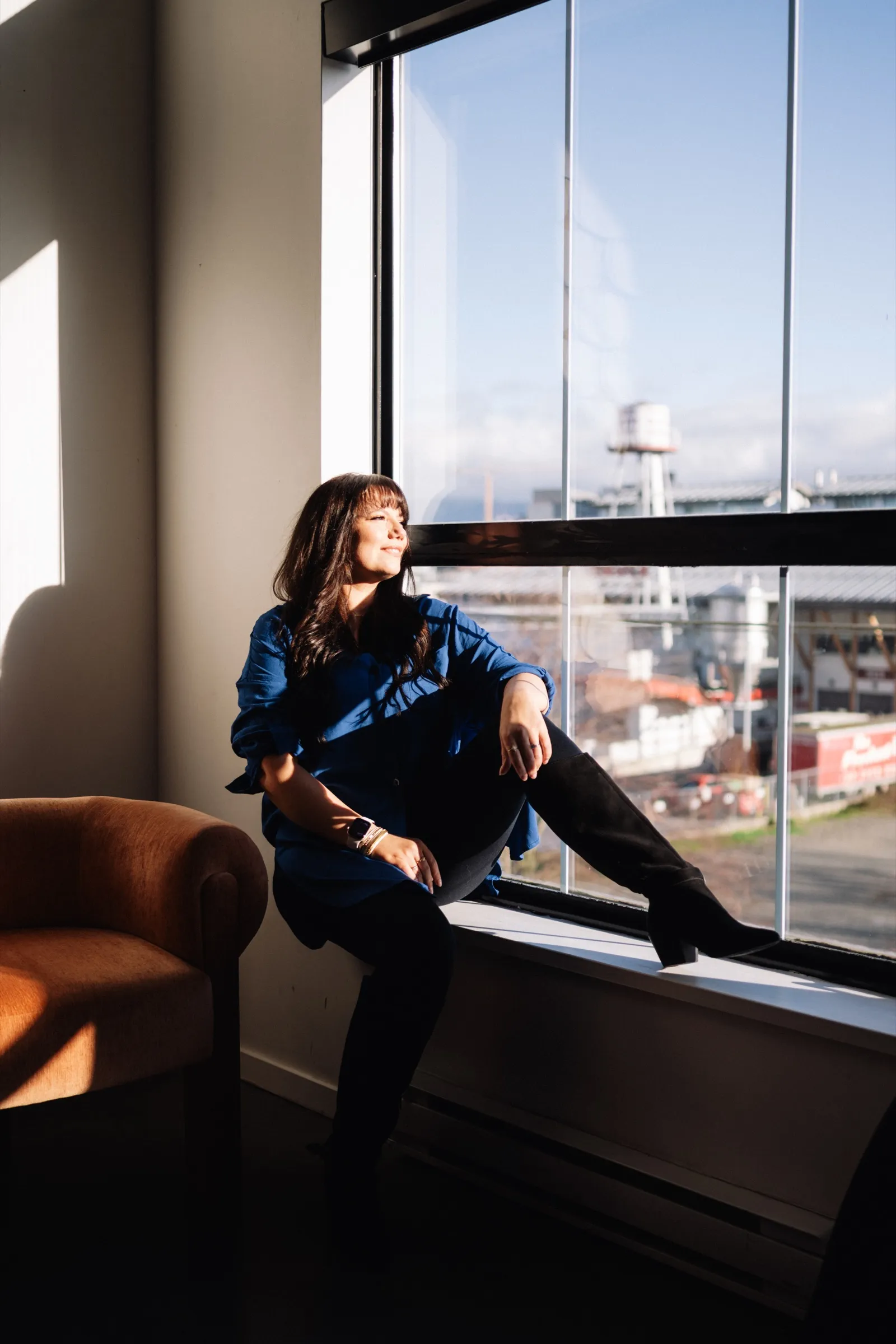 Brooke in a sunlit window, looking out